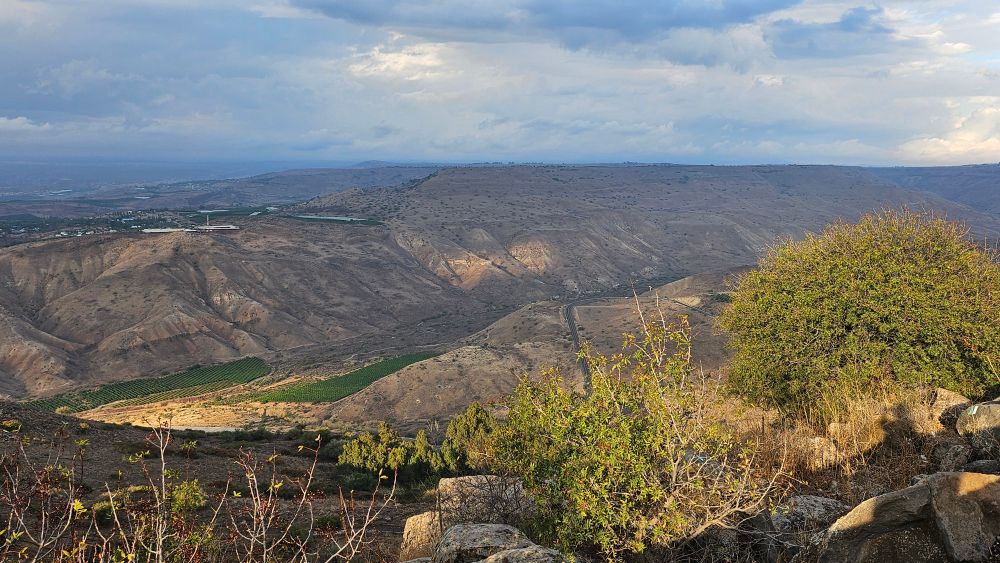 Mountains and a valley under a stormy sky