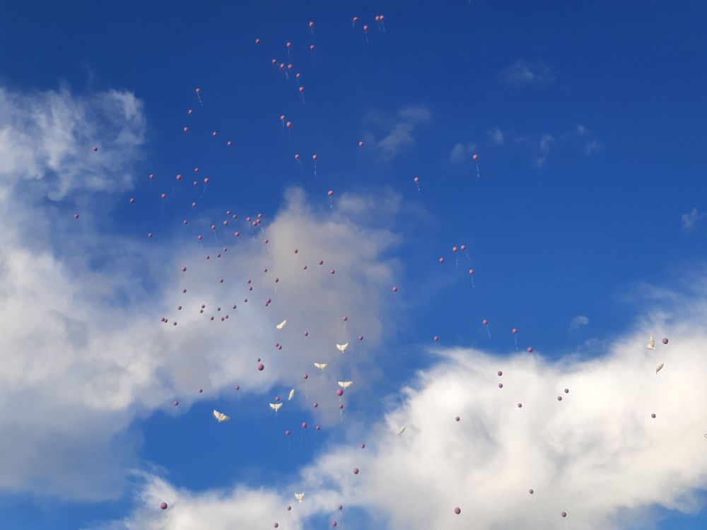 A release of purple and white dove balloons in honor of Makayla Frost Fortner.