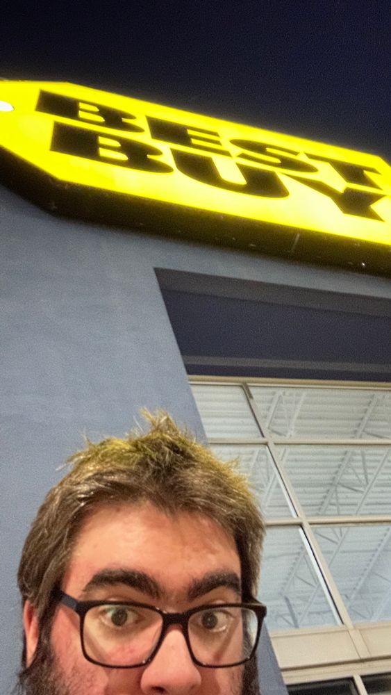 a close selfie in front of a best buy sign