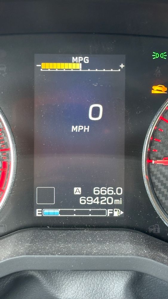 car information screen showing odometer of 69420 miles and a trip odometer of 666