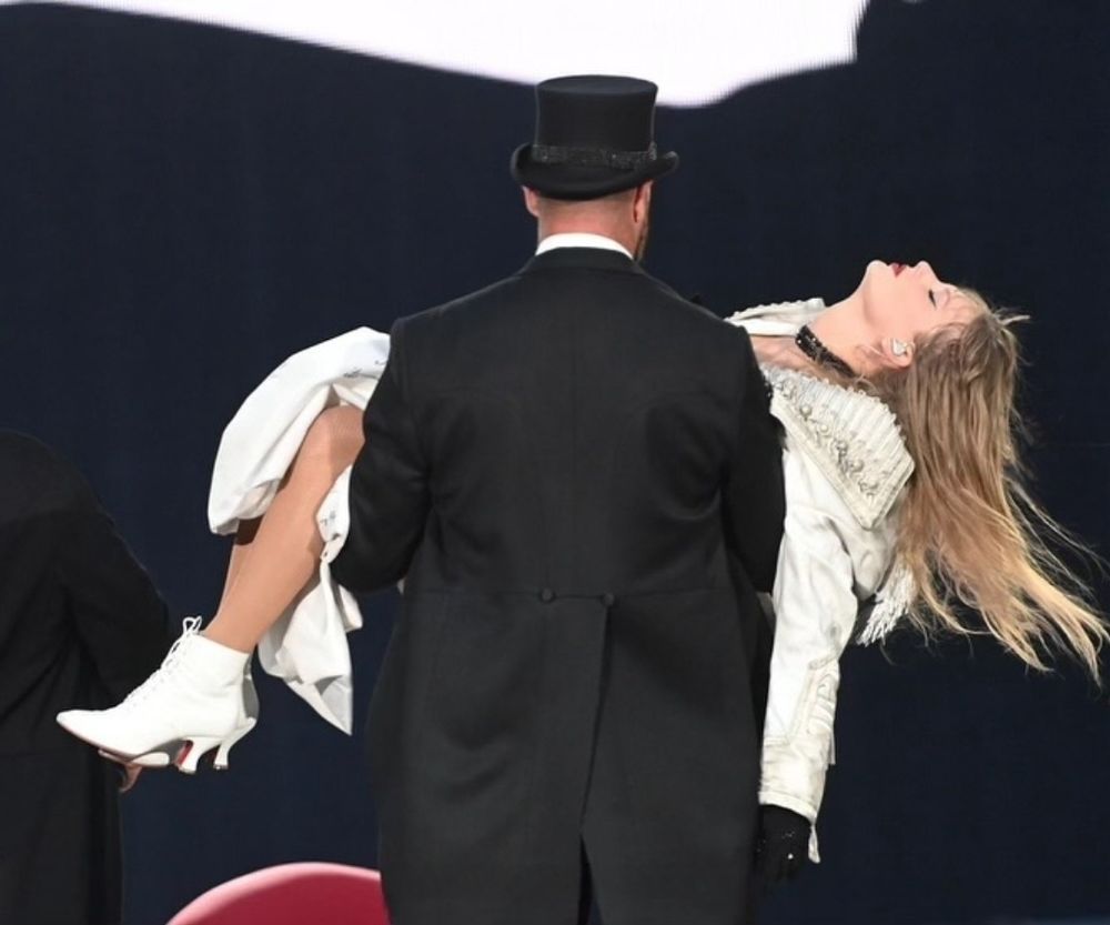 Travis carrying Taylor at Eras Tour