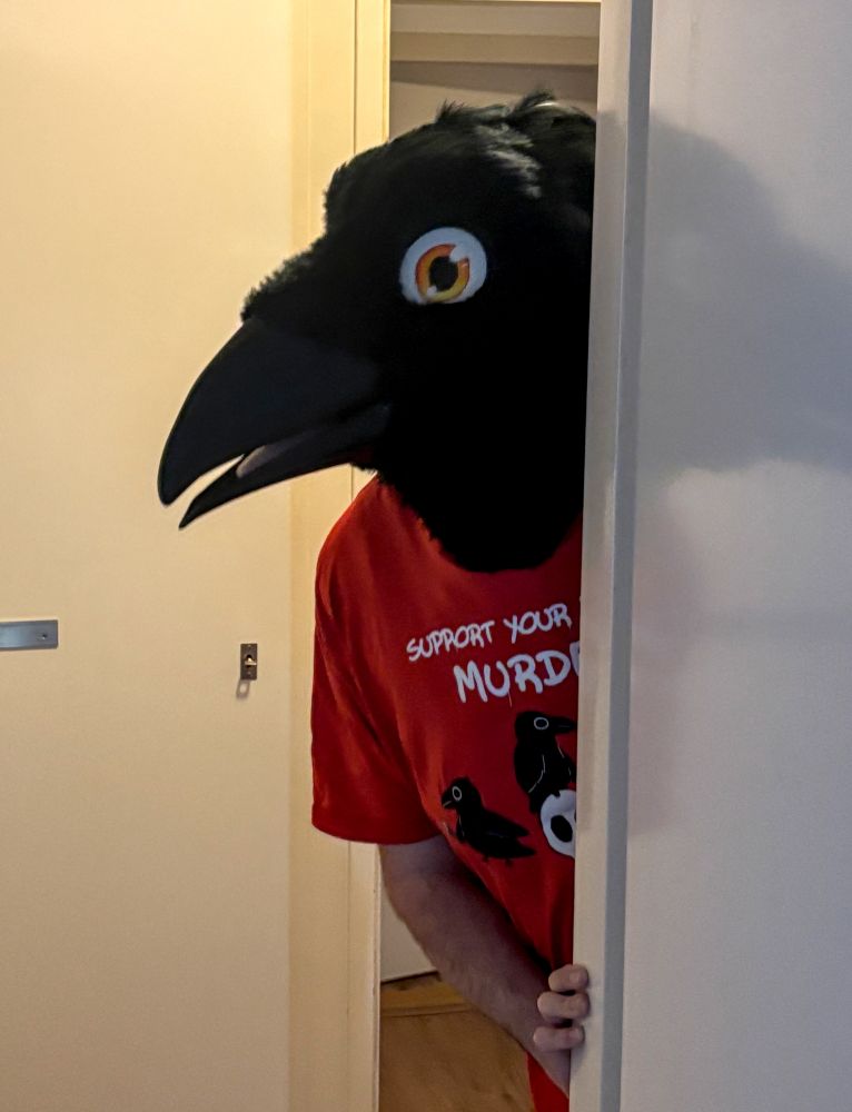crow fursuiter peeking from a door