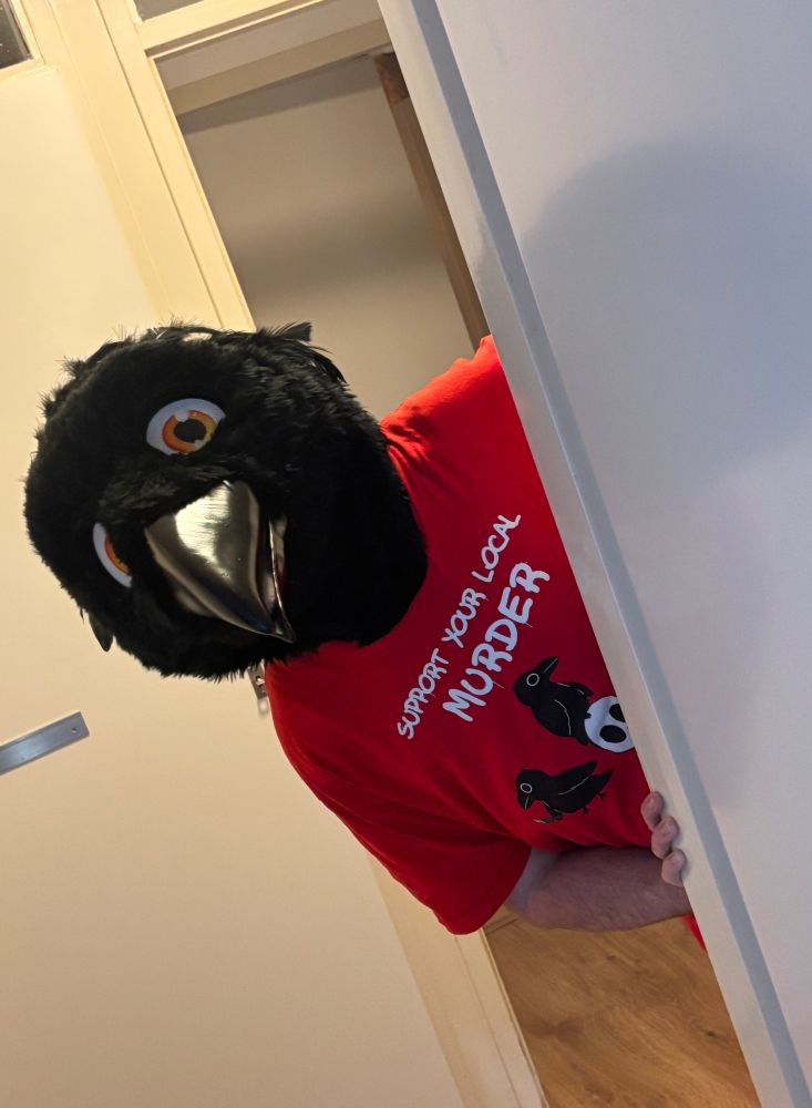 crow fursuiter peeking from a door