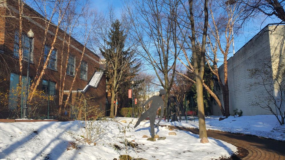 Brick sidewalk through a snowy university campus