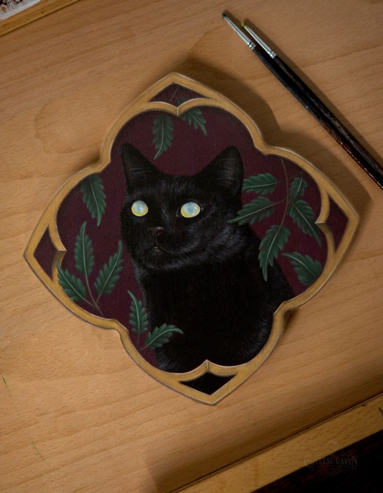 Painting on wood plaque of black house cat bust with white/yellow tinged eyes on a background of reddish purple with green vine leaves surrounding. Towards the edge of the wood plaque is a gold style frame painted, bordering the entire plaque.