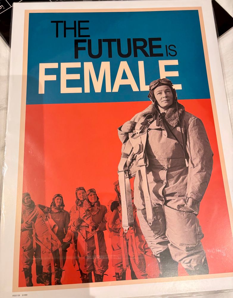 Post with blue and red blocks. There is a woman in aviation gear in the forefront with more women in aviation in the red block. “The future is female” is written in the blue block
