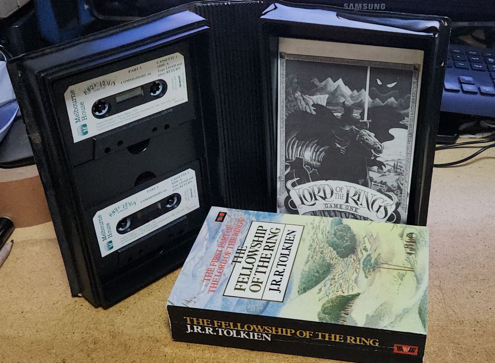 Open Lord of the Rings box with two tapes, manual and a huge Fellowship of the ring book