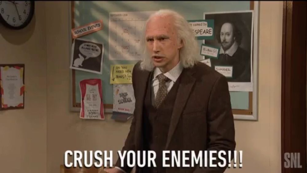 a man in a suit says crush your enemies in front of a bulletin board