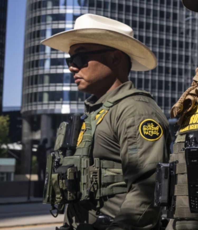 A border patrol dweeb wearing a white cowboy hat 