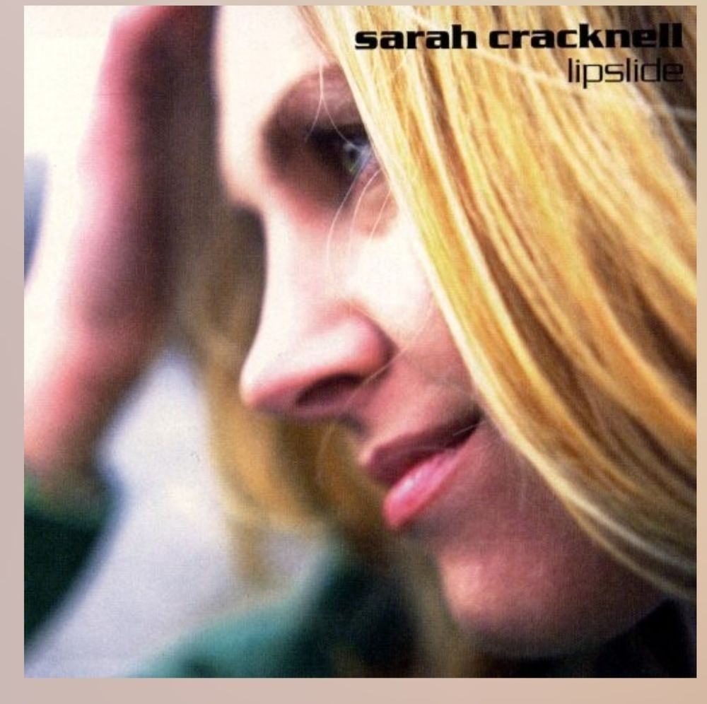 Cover image of Sarah Cracknell's Lipslide album. The UK version. Sarah looks to the left in a close up with her hand fixing her blonde hair in the background. 