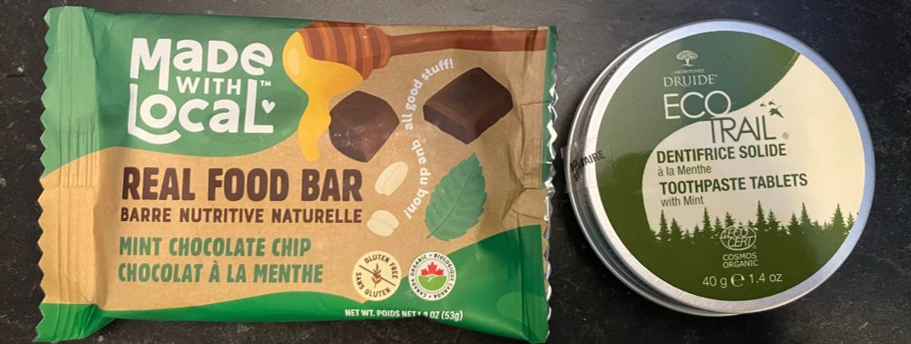 Photo of a chocolate & mint cookie next to a can of cocoa-based toothpaste