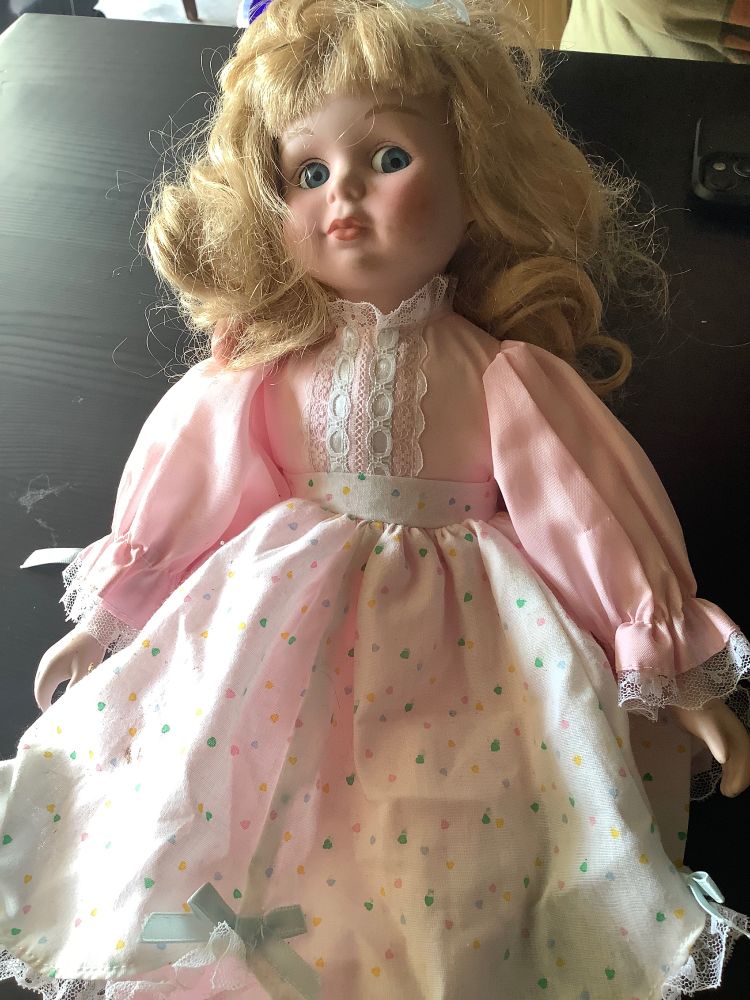 A blonde doll in a pink dress.