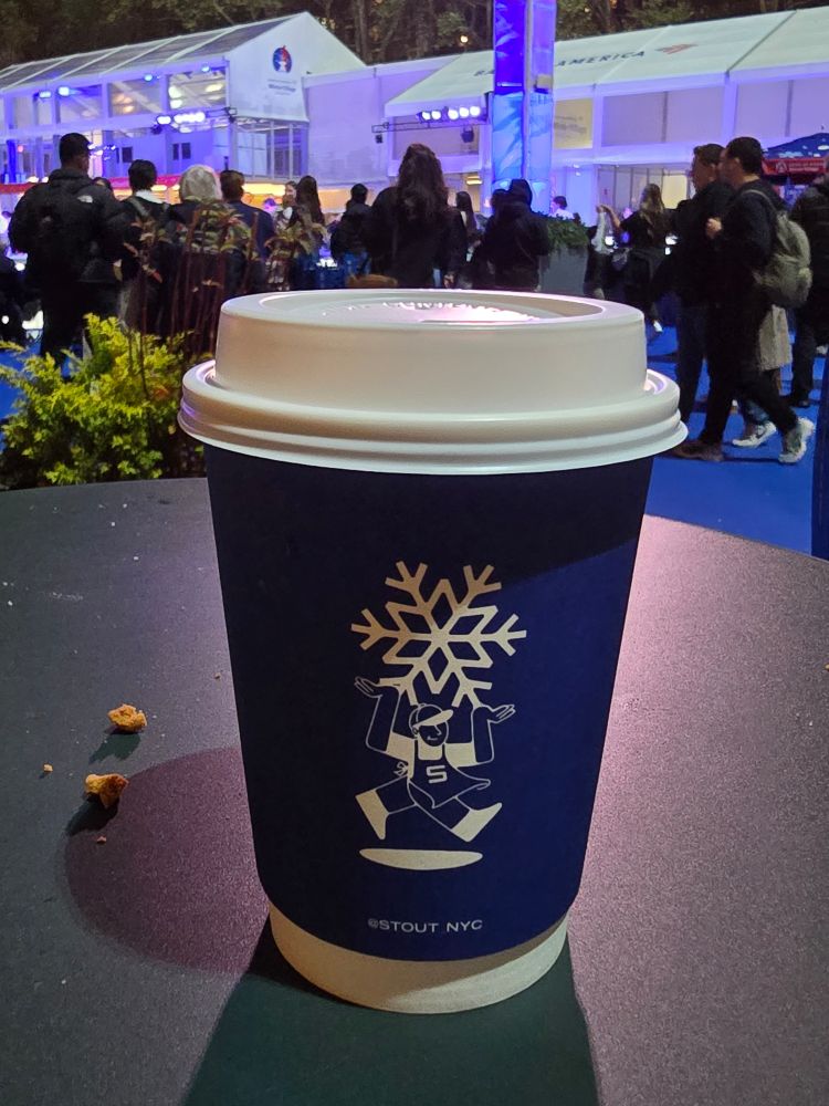 Photo of a mug with a cute snowflake design full of hot whiskey