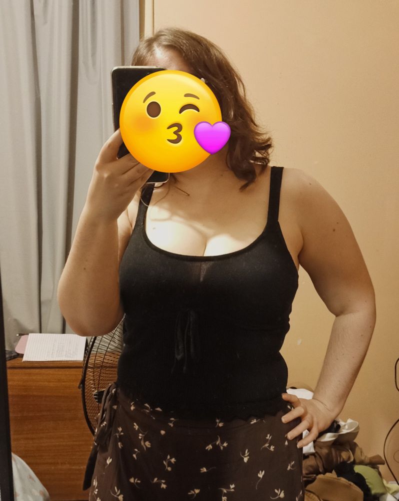 A photo of myself wearing a black tank top with a brown patterned dress. 