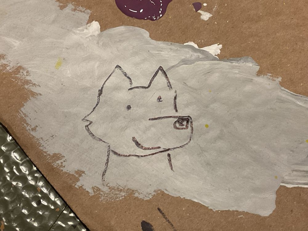 Marker doodle of a wide wolf on silver paint on cardboard 