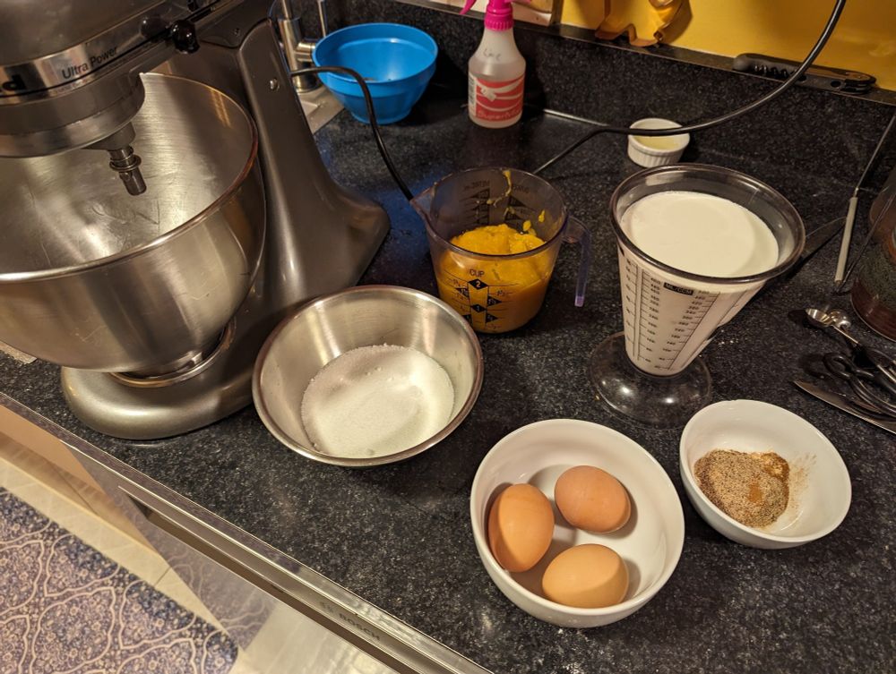 Pie filling ingredients: sugar, pumpkin purée, eggs, half and half, cinnamon, ginger, cloves, and salt.