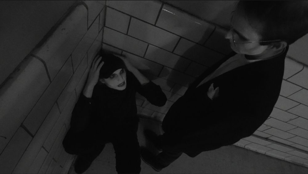 A distorted shot of the headmaster authoritatively looking over Comet in the corner of the infirmary.
