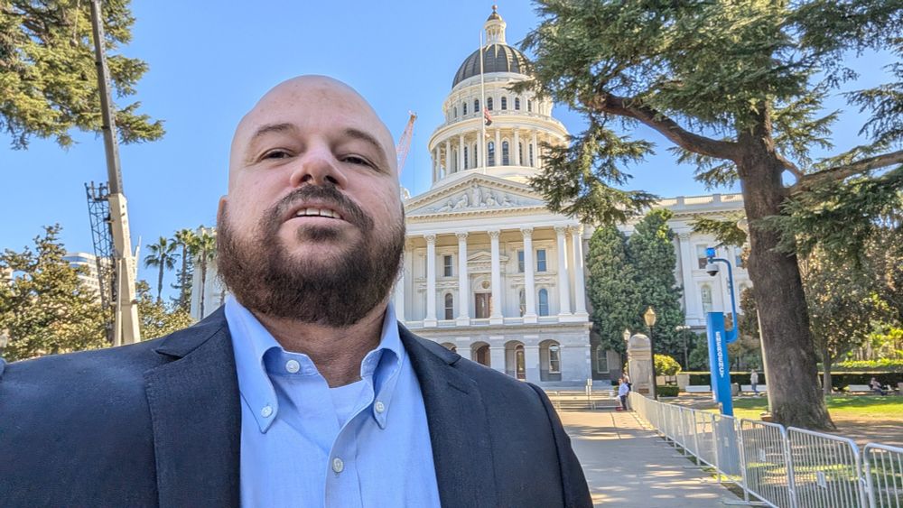 Jason Byors standing in front of the California State Capital Building