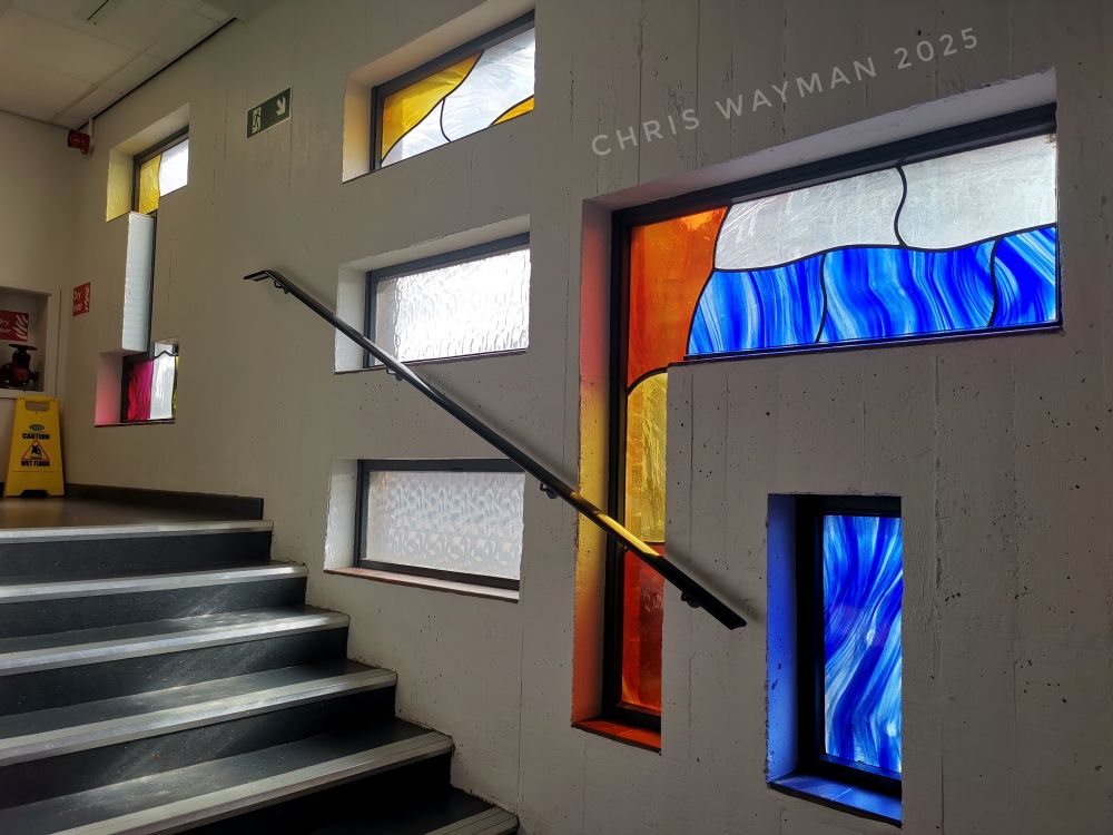 Stairwell with windows. Some coloured glass. 
