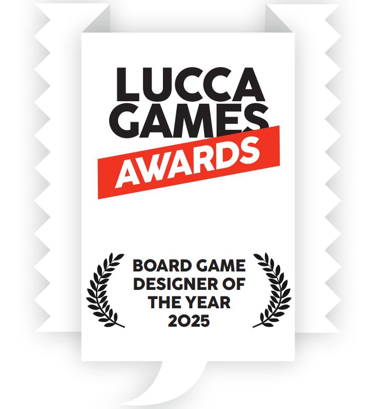 LUCCA GAMES in black, with a red slightly diagonal stripe underneath reading AWARDS in white. below are black laurel leaves surrounding BOARD GAME DESIGNER OF THE YEAR 2025