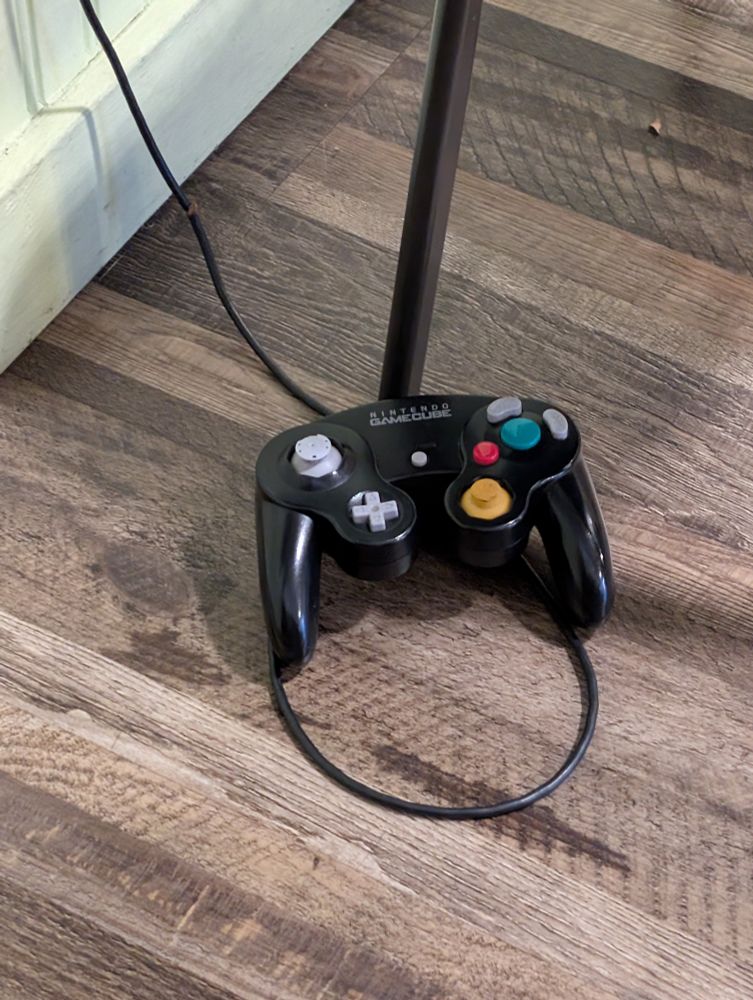 a picture of a nintendo gamecube controller on the ground