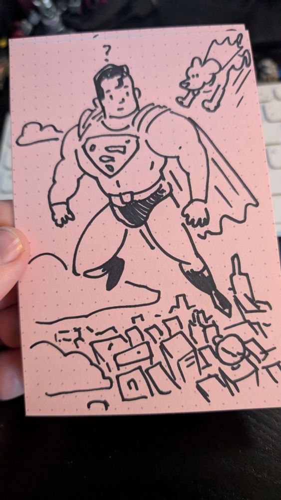 A sketch of Superman flying above the city - with Krypto sneaking up on him 
