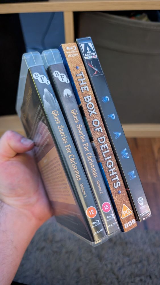 My wonderful hand holding four Blu-rays. Ghost Stories for Christmas Vol 1 and 2. The Box of Delights. Spawn.
