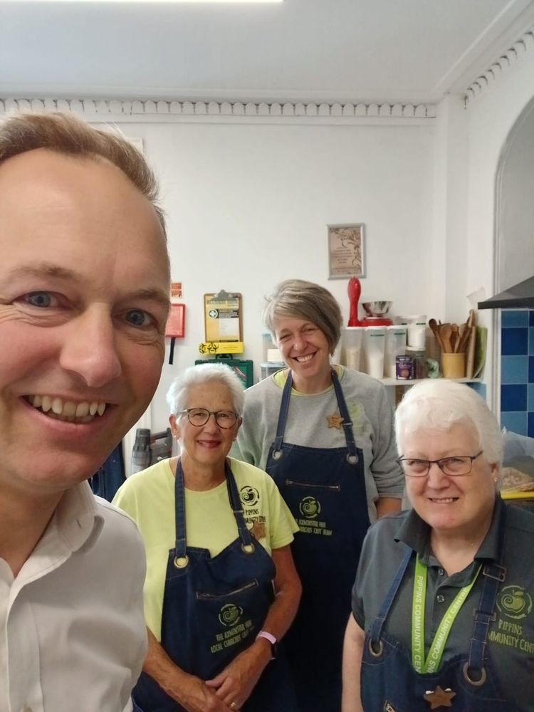 A selfie taken by Richard Foord with three people wearing aprons branded with Pippins Community Centre