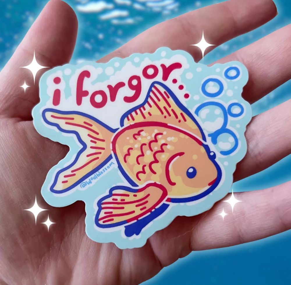 A sticker of a digital drawing of a goldfish with text that says “I forgor”