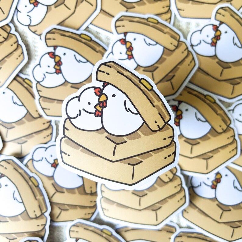 Illustration of 2 chickens nestled within waffles as a sticker. 