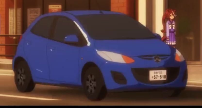 screenshot of a 2D illustrated Mazda2 car in an anime, but the Mazda logo, which normally resembles the letter M, is flipped upside down, like a W