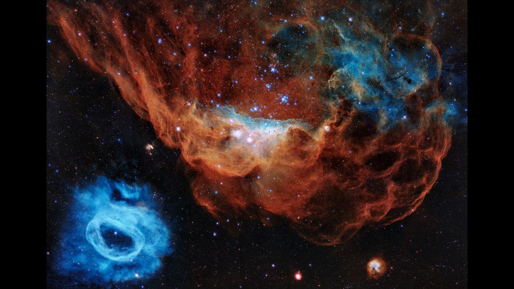 Cosmic cliffs. An image from the Hubble space telescope of a blue nebula and a red nebula.