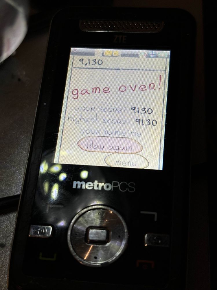 A ZTE C70 that was flashed with a patched firmware to enable unsigned BREW applications to run. In this case, a backup of Doodle Jump from another BREW device is shown running on the phone.
This specific C70 had a blown diode affecting its ability to run off of battery power, which was also replaced.
