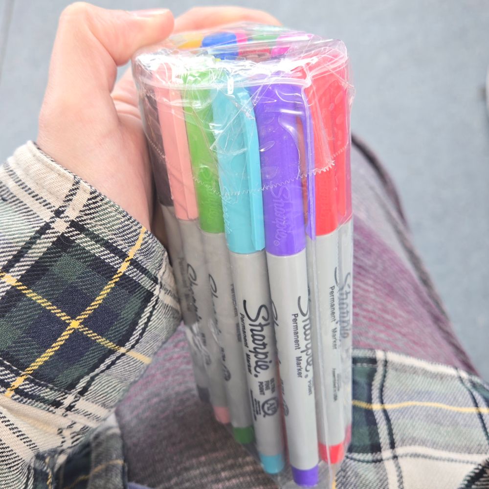 A bundle of 24 colorful sharpie markers, wrapped together in plastic.