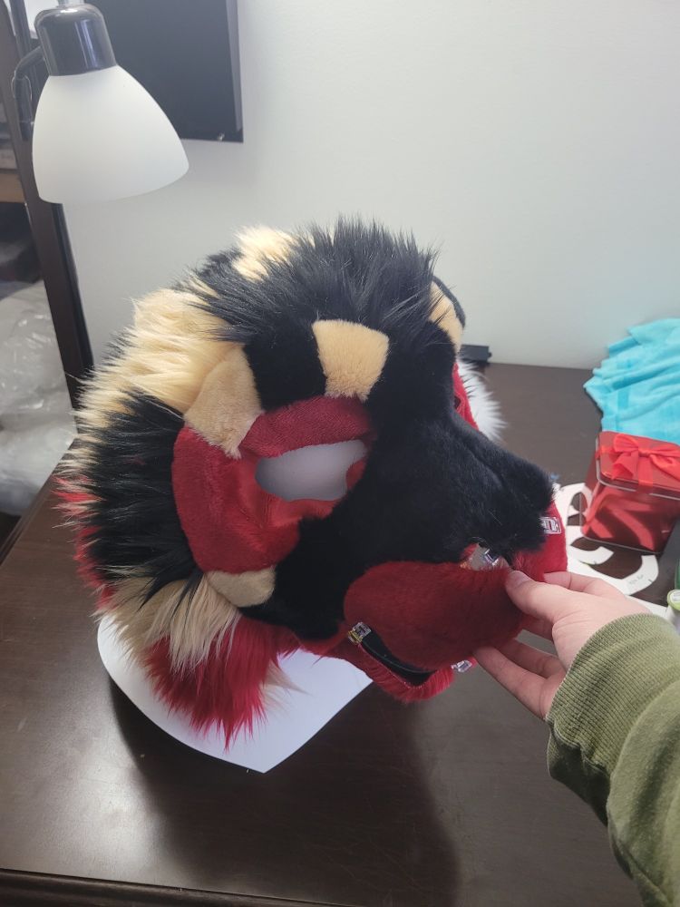 Work in progress photo for a tan, black and red tiger fursuit head