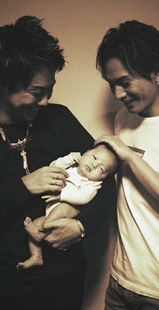 Exile Takahiro and Hiroomi Tosaka pictured with Takahiro’s infant daughter. 