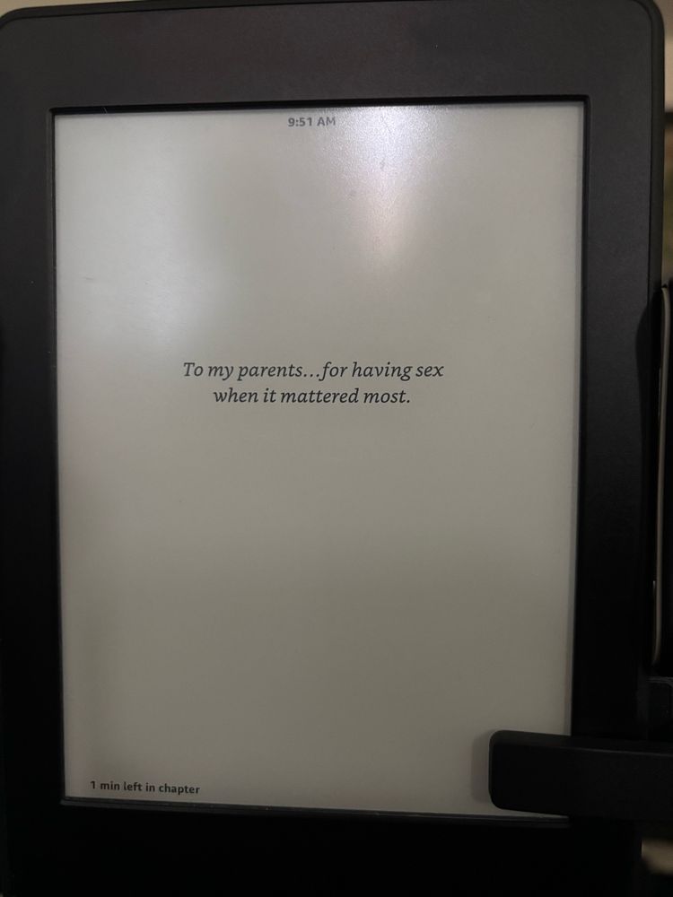 Book dedication on a kindle saying, “To my parents… for having sex when it mattered most.”