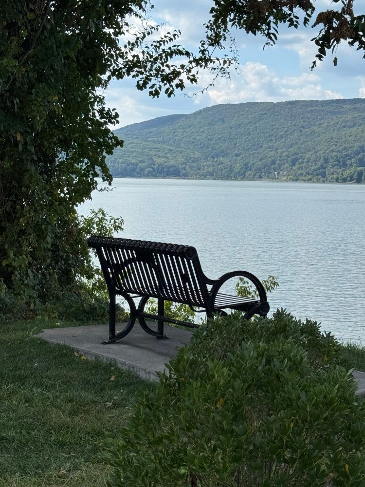 Bench in a shady spot to relax by the Hudson River near Fleischman’s Pier in Peekskill 