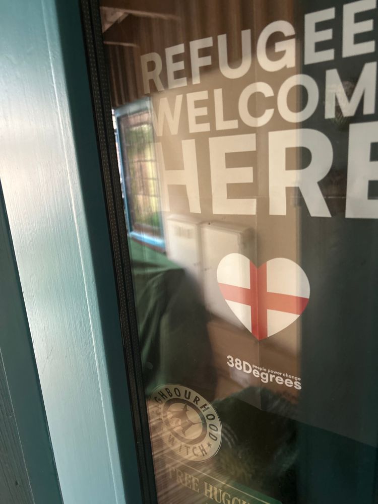 Poster displaying a St George’s flag in a heart shape welcoming refugees