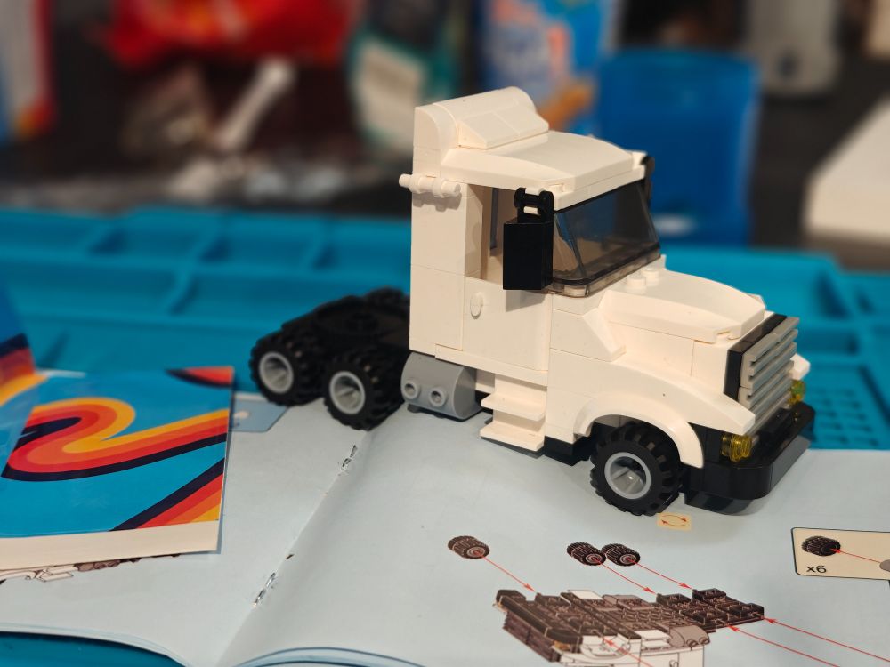 Picture of a white truck made from building blocks. 