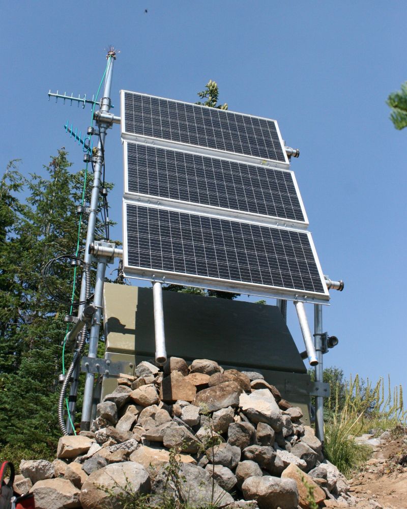 A seismic monitoring station is on a rocky hilltop.