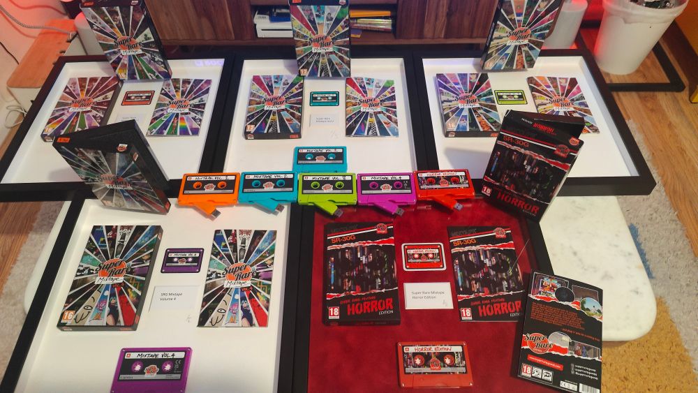 A photo of 5 frames with cassette-shaped USBs and a box within each frame. They comprise Super Rare Mixtape Vol 1, Vol 2, Vol 3, Vol 4, and the Super Rare Mixtape Horror Edition, each with a different coloured cassette USB 