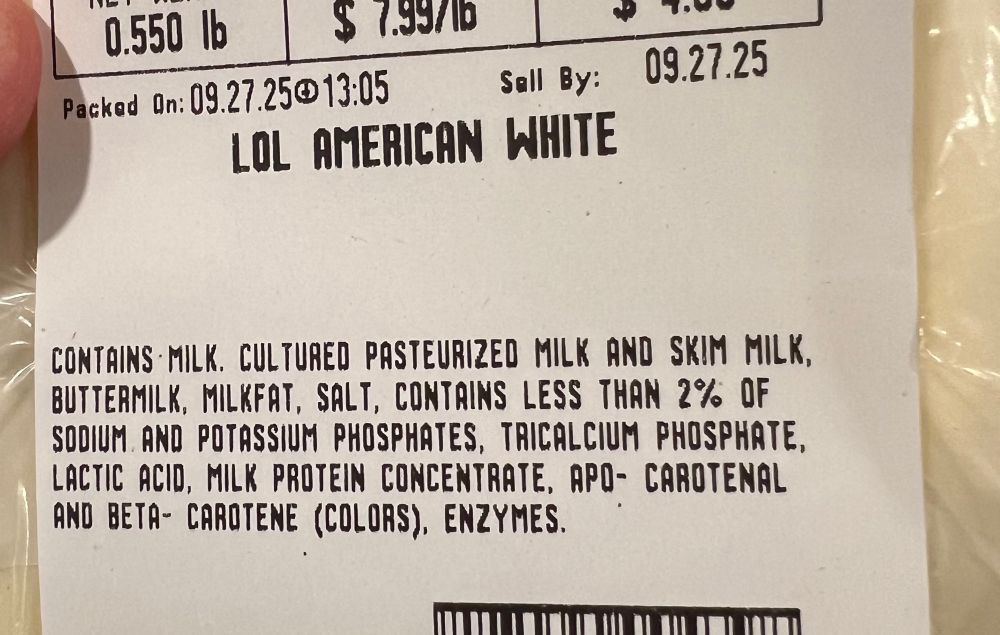picture of some cheese from a supermarket deli. the label says “LOL American White”