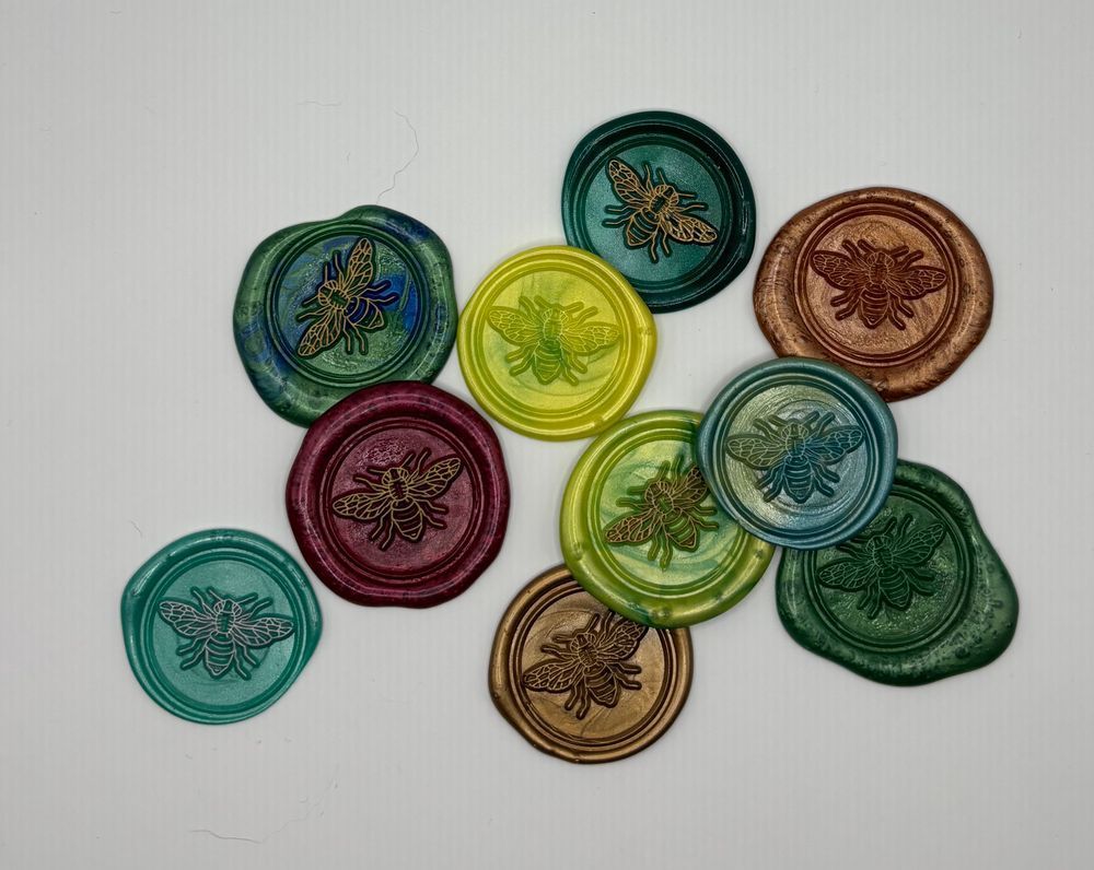 A set of 10 bee wax seals. Each seal is made in a different color.
