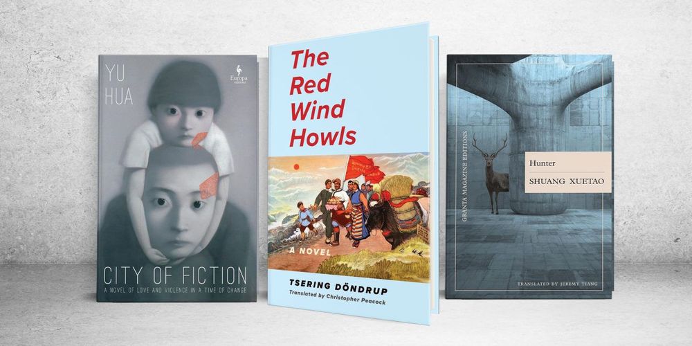 Three translated novels stand upright against a concrete background. From left to right: 'City of Fiction' by Yu Hua, 'The Red Wind Howls' by Tsering Döndrup, and 'Hunter' by Shuang Xuetao. Each cover features distinct surreal, political, or architectural artwork and muted tones.