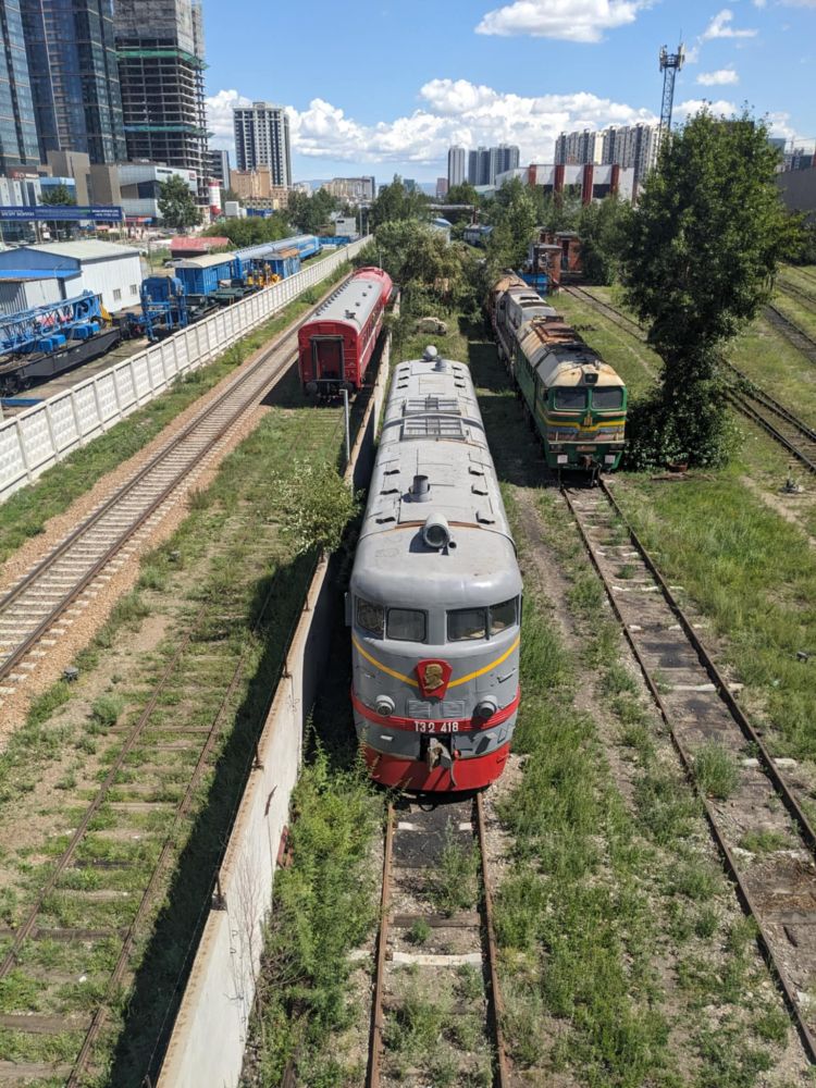 An old diesel (I think) locomotive parked in a siding just to the east of Ulaanbaatar's central railway station. It's grey and red with a yellow lightning bolt stripe running around its front.