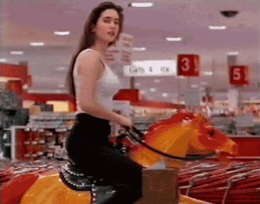 a woman is riding a rocking horse in a store with the number 3 in the background