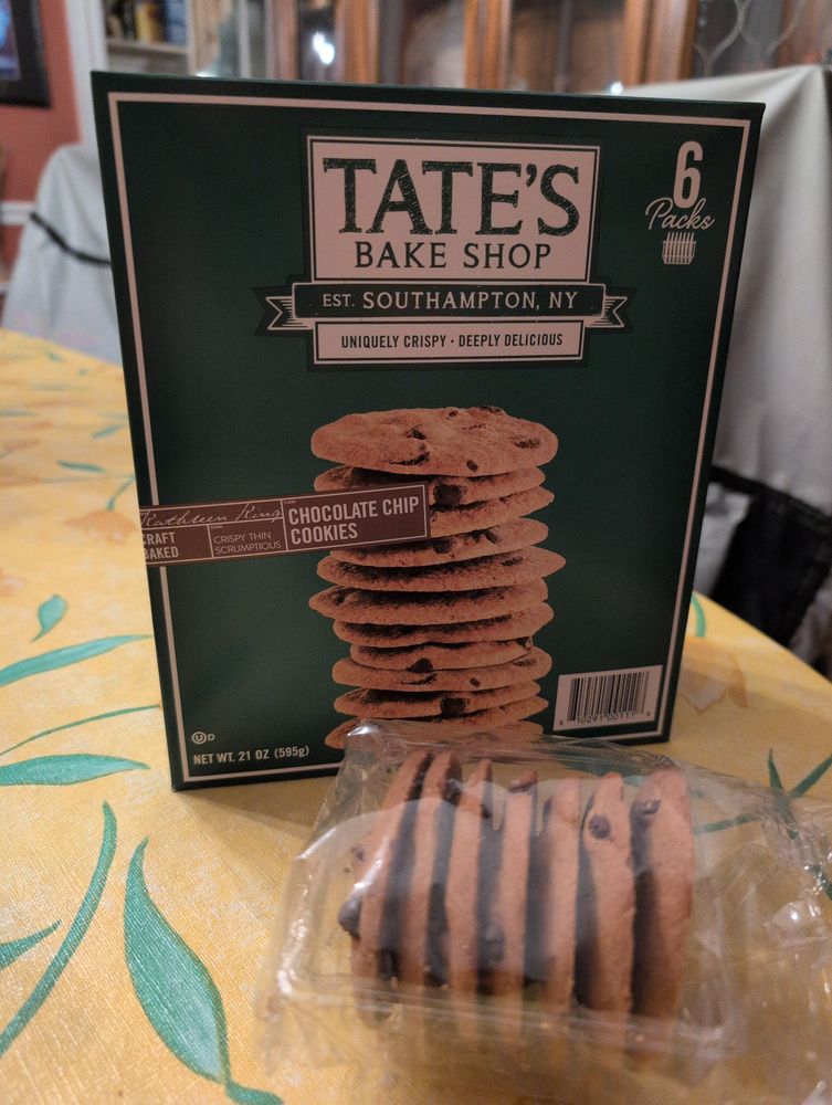 Box of Tate's Bake Shop chocolate chip cookies, with a plastic package of seven cookies from inside the box sitting in front of it