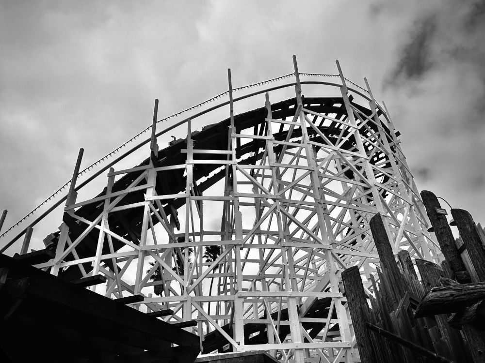 Black and white photo of a 100-year-old wooden roller coaster.