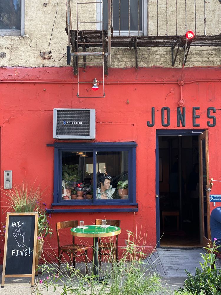 Profile shot of The Jones facade and entrance with an Elvis bust in the window. 